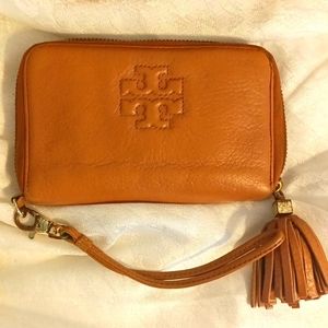 Tory Burch camel tan color pebbled leather zip around tassel wristlet